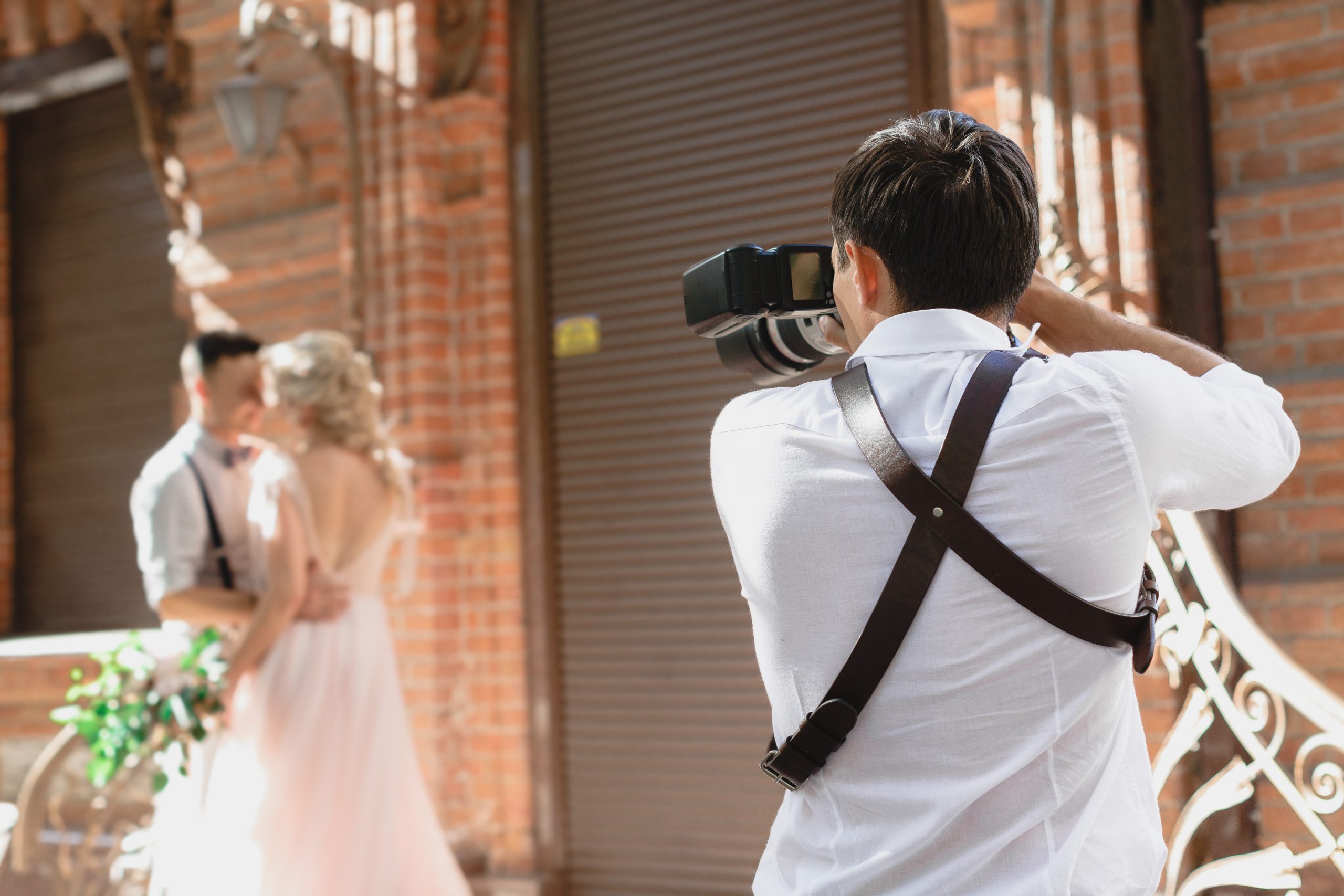 wedding-photographer-takes-pictures-bride-groom-city-wedding-couple-photo-shoot-photographer-action